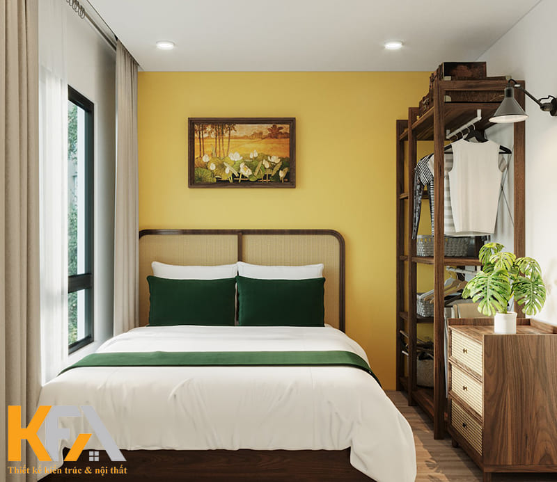 Bức tranh treo tường và chậu cây xanh khiến phòng ngủ thêm phần sức sống